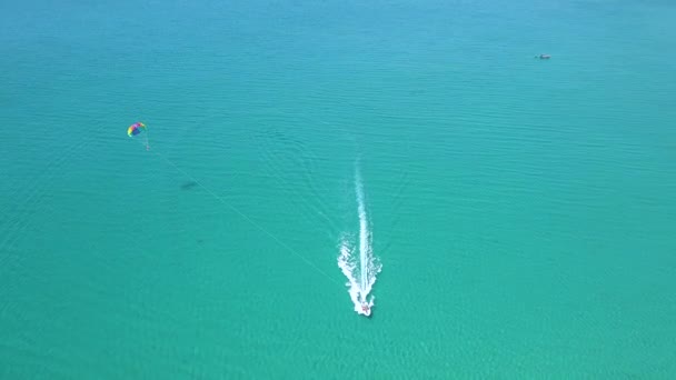 Parasol vista Drone volando sobre el mar azul. Vista aérea paradójica. Actividad de verano y entretenimiento extremo mientras descansa en la playa del resort . — Vídeos de Stock