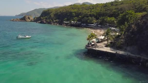 People swimming in sea and resting on resort beach aerial view. Summer beach and crystal clear water aerial landscape. Drone view sandy beach on tropical island landscape. — Stock Video