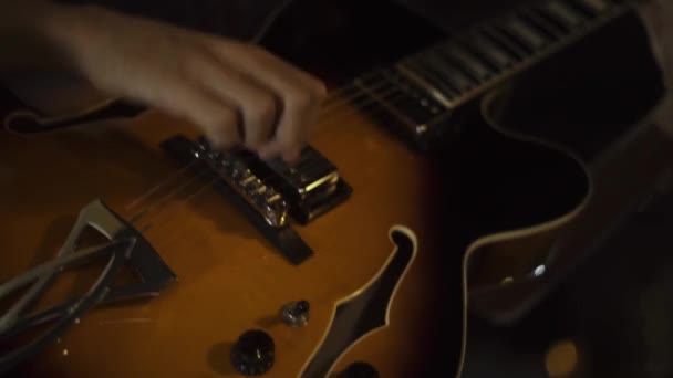 Musiker som spelar gitarr på musik konsert. Nära håll händerna på gitarr spelare spelar musik till gitarr på scen. Musikaliska solo prestation. — Stockvideo