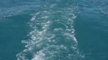 Mavi deniz yüzeyi Yelkenli tekne arkasında Kapat su izi. Deniz suyu ile köpük ve dalgalar, dökülmeleri, bubbles, köpük, gemi yüzer sonra izleri iz.