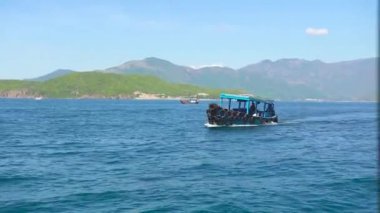 Yeşil dağ manzara mavi denizde yüzen gemi. Turkuaz deniz suyu, yeşil dağ ve berrak gökyüzü ufukta yelken tekne.