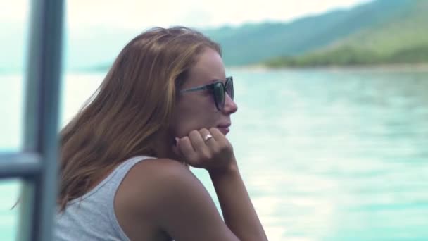 Young woman on sailing ship on sea and green hills landscape. Beautiful woman enjoying sailing on board of sea ship while summer travel. — Stock Video