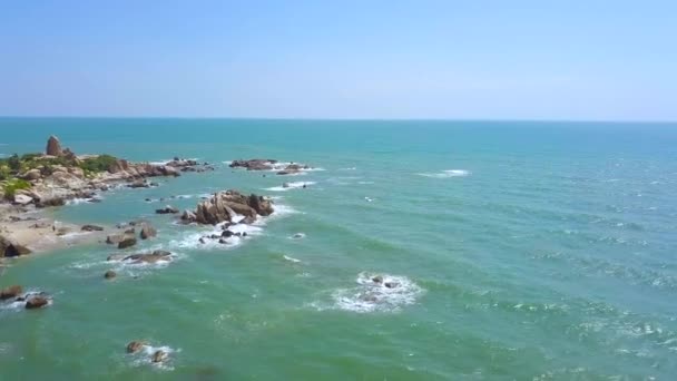 Ilha penhasco no mar azul e ondas de água salpicando paisagem de drone voador. Ilha rochosa em água azul do oceano e vista aérea do horizonte . — Vídeo de Stock