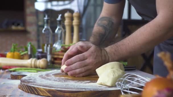 Hand of baker kneading dough for pizza preparation. Chef cook making dough for baking cake on wooden table. Process preparation homemade pastry. Cooking pasta, spaghetti, food concept. — Stock Video