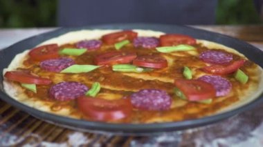 Domatesli, biberli sosis ve fasulye masada ham İtalyan pizza. Pizzaillo İtalyan pizzacı pizza yapma eller. Işlem hazırlama ulusal mutfağı. Geleneksel yemek pişirme.