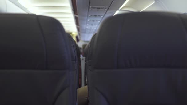 Passengers seats in economy class modern airplane while flying in sky. Passengers chairs inside cabin commercial plane while flight. People traveling by modern commercial airplane. — Stock Video