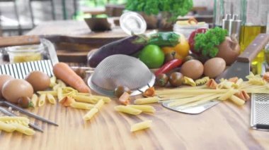 İtalyan yemeği arka plan. Ahşap masa üzerinde makarna ve spagetti. Yumurta ve sebze gıda Akdeniz mutfağının yemek için. Sağlıklı bir diyet ve beslenme için taze madde. Makarna koleksiyonu.