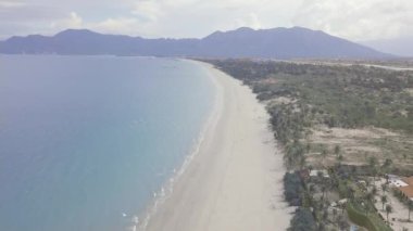 Mavi deniz ve kumlu plaj dağ manzara görünümünde uçan drone. Güzel sahne deniz kıyısı, tatil oteli ve dağ ufuk havadan görünümünde.