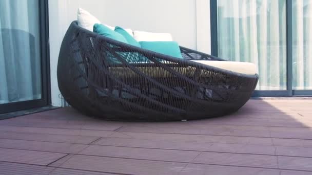 Cozy rattan sofa with cushions in lounge area on summer terrace luxury villa. Garden furniture for summer holidays on mainson veranda. — Stock Video