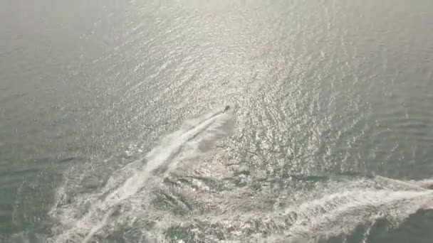 Gün batımında mavi denizde su jeti kayak pistine binen insanlar. Drone açık suda jet ski sürüş insanlar görünümü. Yaz tatilinde su sporu. Su sporları motor sporları — Stok video
