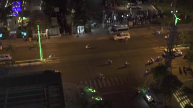 Çatıdan deniz kıyısı görünümünde Gece Hayatı modern şehir. Motosiklet ve araba deniz plajı manzara palmiye ağaçları üzerinde gece şehir yolda sürüş. Gece kentsel peyzaj.