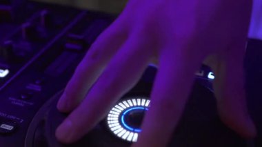 Dj gece kulüp partisinde renkli ışık karıştırma konsolunda müzik çalıyor. Dj mixer çalar ve disko parti için müzik konsolu. Renkli ışıklı disk jokey paneli ve karıştırma güverte.