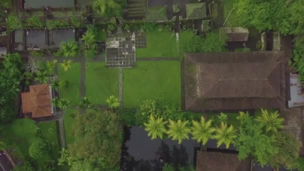 Indonesian architecture building and Hindu temple with water pond on tropical Bali island. Aerial view territory Hindu temple with tropical garden and pond. Asian culture. Tourism and travel concept. — Stock Video