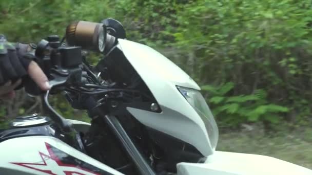 Motorcyclist riding on motorcycle on road while moto travel. Biker man driving on motorbike on countryside road. Motorcycle traveling. Moto lifestyle — Stock Video