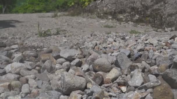 Motorcyclist riding on motorcycle on gravel road in mountain. Moto biker driving on motorcycle at rocky off road. Moto sport and travel. Motorcycle lifestyle. — Stock Video