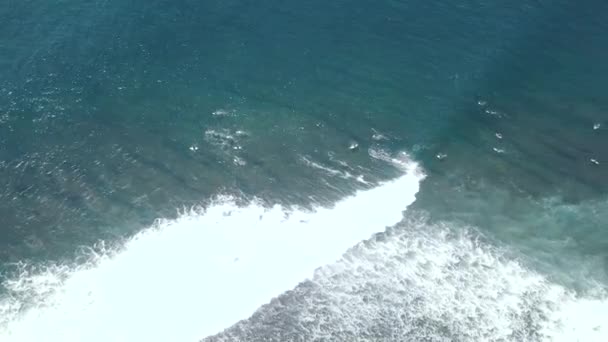 Vista dall'alto verso il basso dei surfisti nel mare blu smeraldo cavalcando onde e facendo acrobazie . — Video Stock