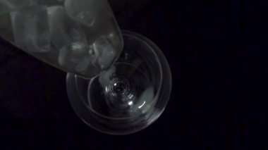 Gecenin karanlığında şarap bardağına buz doldurma manzarası..