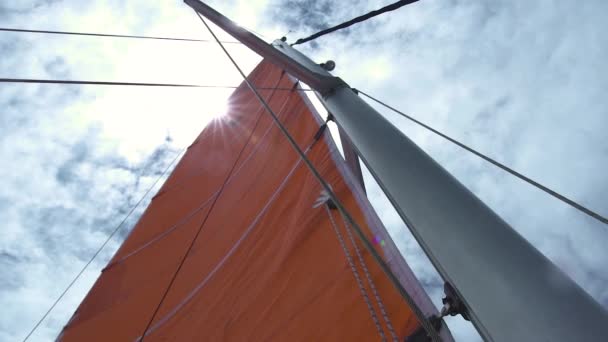 Vista de vela mayor, mástil y cuerdas desde un ángulo bajo con el sol brillando por encima. — Vídeos de Stock