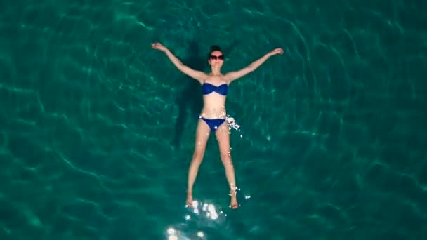 Een mooi meisje in de zee dragen van een zonnebril Rechtenvrije Stockvideo