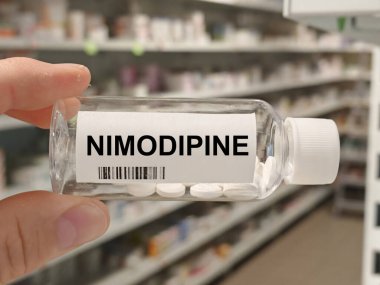 Box of NIMODIPINE tablets on a hospital pharmacy table used to prevent cerebral vasospasm a calcium channel blocker.