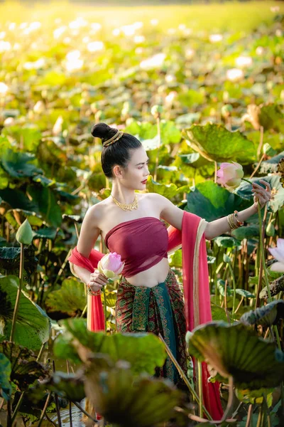 Asian woman collecting lotus flowers and she wear Traditional Thai dresses — Stock Photo, Image