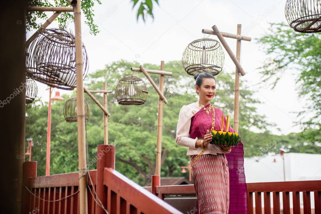Beautiful woman hold floating basket or kratong, loy kratong festival in Thailand