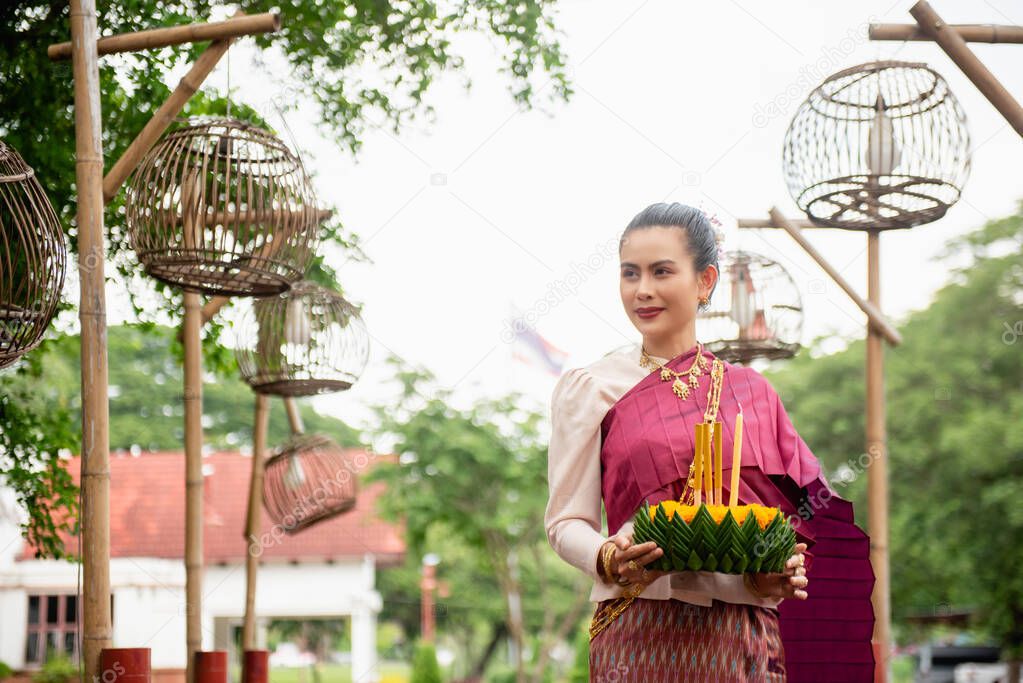 Beautiful woman hold floating basket or kratong, loy kratong festival in Thailand