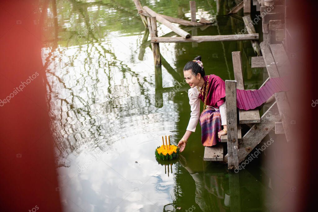 Beautiful woman hold floating basket or kratong, loy kratong festival in Thailand