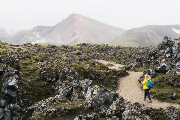 Femme Imperméable Jaune Marchant Travers Champ Lave Vers Les Montagnes — Photo