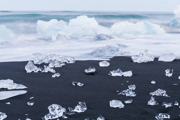 Icebergs floating and melting in arctic ocean. Pieces of ice drifted out of Jokulsarlon lagoon, Iceland.