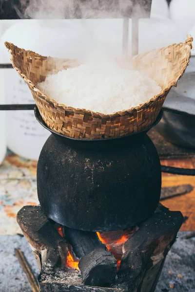White laotian steam rice cooking on wood burning stove in Luang Prabang, Laos