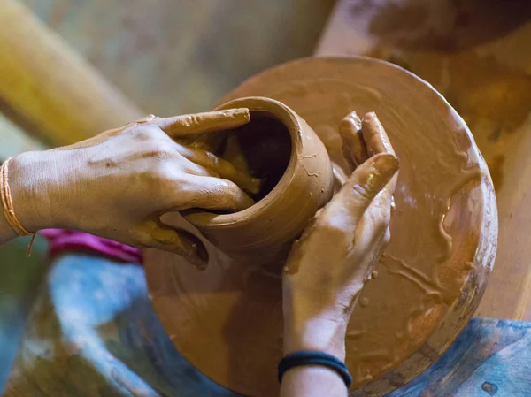 Hands of a potter, creating an earthen jar on the circle — Stock Photo, Image