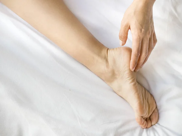 Primer plano de la pierna de las mujeres con crema hidratante — Foto de Stock