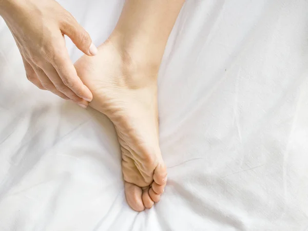 Primer plano de la pierna de las mujeres con crema hidratante — Foto de Stock