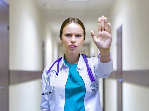 Serious Female Doctor Stethoscope Showing Stop Sign Hospital Corridor — Stock Photo, Image