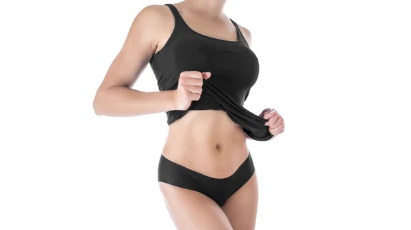 Vista de cerca del cuerpo curvilíneo bien formado de una joven bronceada sexy en lencería negra, vista del torso en blanco — Foto de Stock