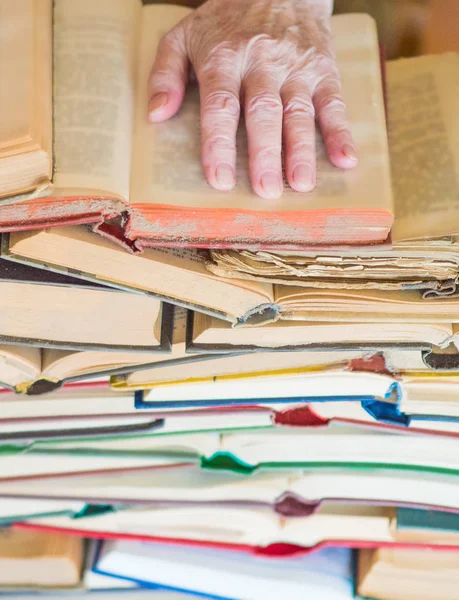 Never too old to learn - Hands of old woman reading book