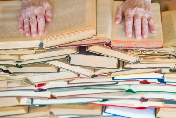 Never too old to learn - Hands of old woman reading book