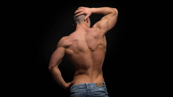 Shirtless man in jeans on hips put his hand on waist — Stock Photo, Image