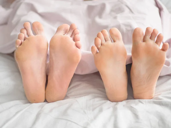 Närbild Mänskliga Fötter Sover Tillsammans Sängen Täcket — Stockfoto