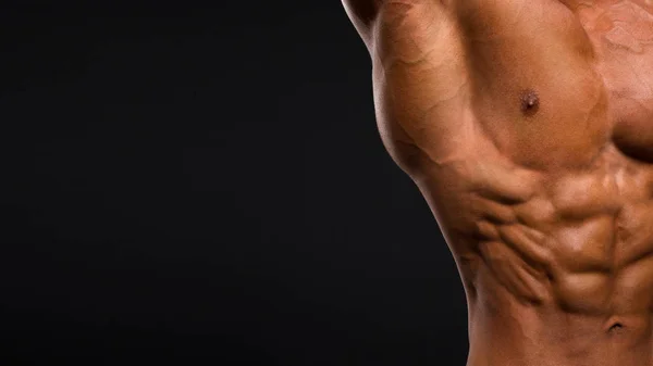 在深色背景上强体育人健身模型躯干显示六块腹肌 — 图库照片