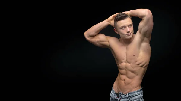 Portrait of strong healthy handsome Athletic Man Fitness Model posing near dark gray wall — Stock Photo, Image