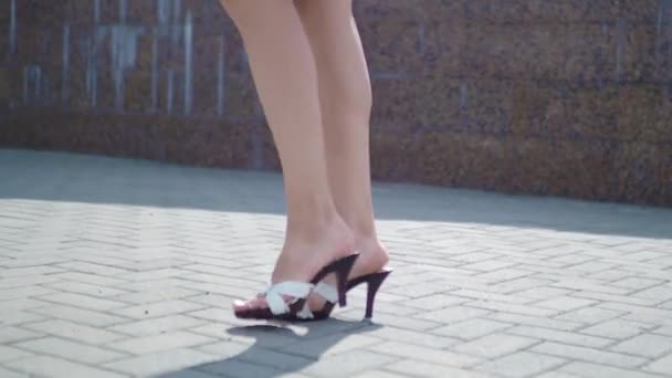 Pernas femininas em sapatos de salto alto andando na rua urbana. Pés de mulher de negócios jovem em calçado de salto alto que vai na cidade. Menina pisando para o trabalho — Vídeo de Stock