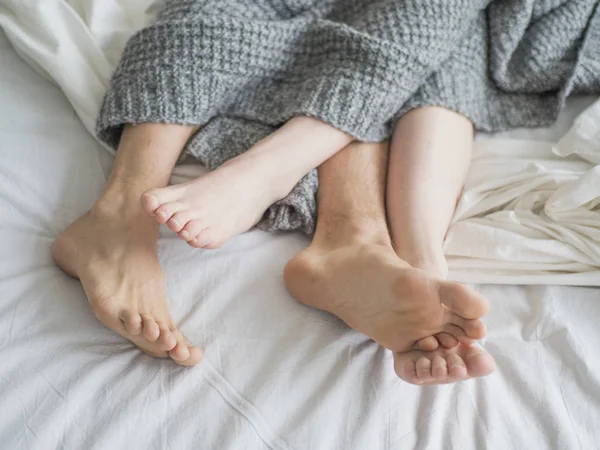 Couple sleeping in bed. Close up view of a feet of a couple. Love and relationships concept — Stock Photo, Image