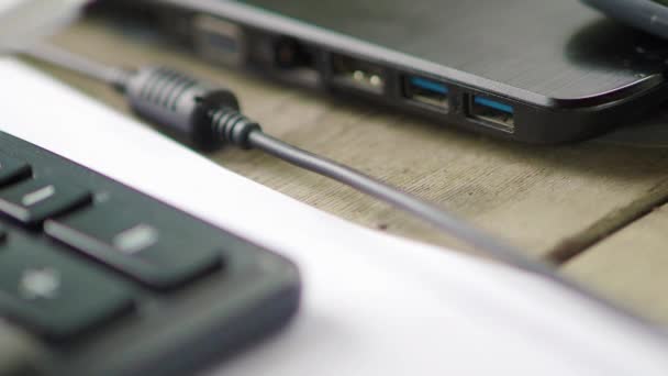 Closeup of USB flash drive inserted into port on the side of a laptop. — Stock Video