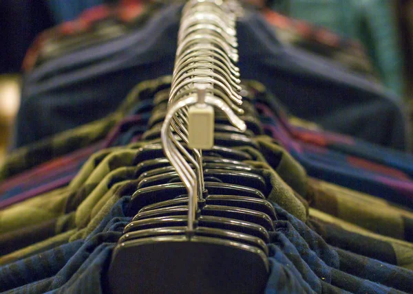 Shirts hanging stack,close up. Sale and shopping concept.