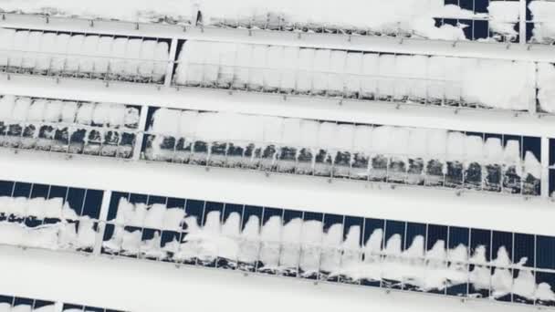 Flying over the farm solar panels in the winter after the cyclone. Panels under the snow. — Stock Video