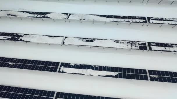 Aerial view of a snow on solar panels farm in winter — Stock Video