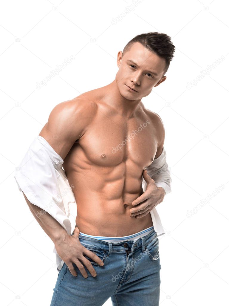 Muscular man with shirtless torso. white shirt and blue jeans isolated on white