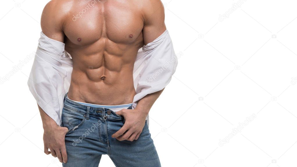 Male torso with perfect abs. Man in blue jeans and white shirt isolated on white.